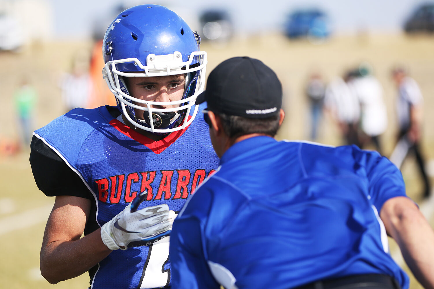 Dylan Fauber asks head coach David Largent if he can call the next play